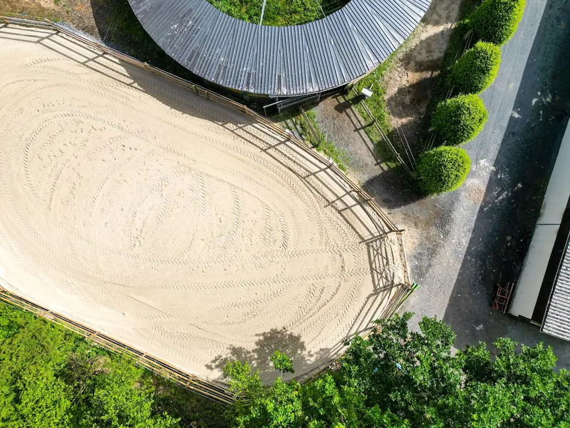 Aerial view of the sand arena at Écurie de Beauclerc